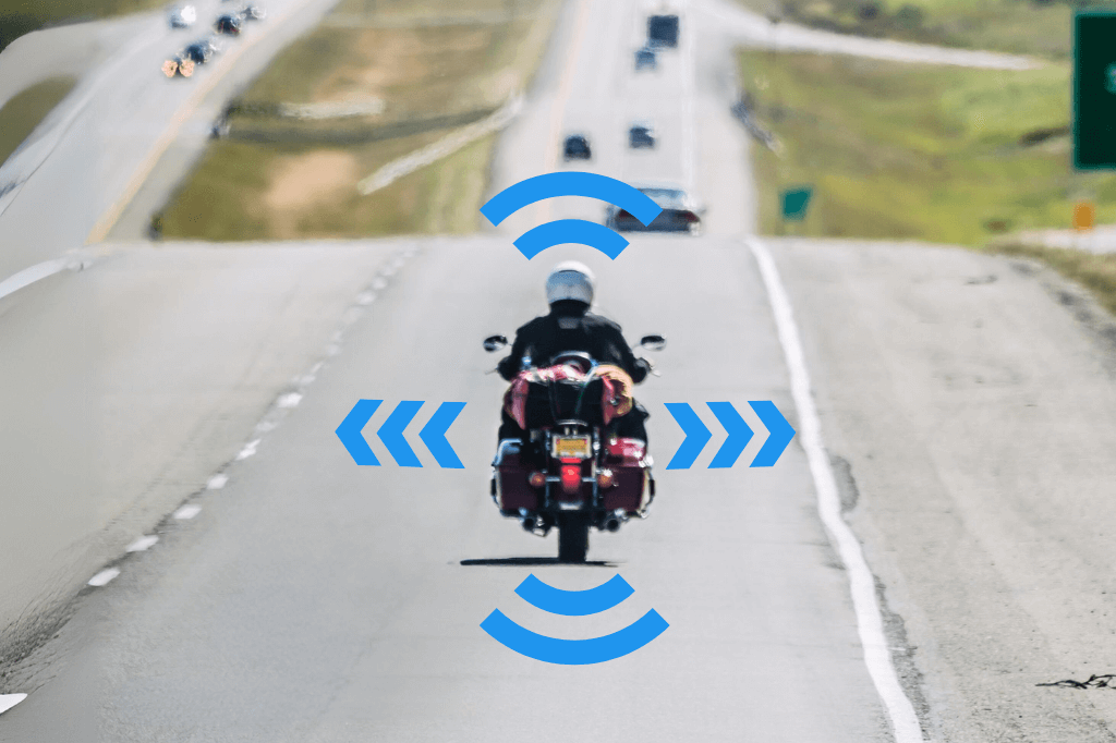 Motorcycle driving on a busy highway, with arrows indicating directions on each side and front and back.